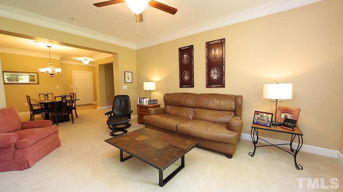 100 Northbrook Drive, Unit 203 Raleigh, NC 27609 - Photo 8 of 39 a living room with furniture and a lamp