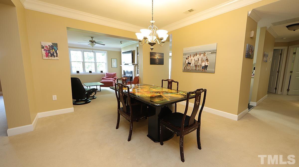 100 Northbrook Drive, Unit 203 Raleigh, NC 27609 - Photo 9 of 39 a view of a dining room with furniture and chandelier