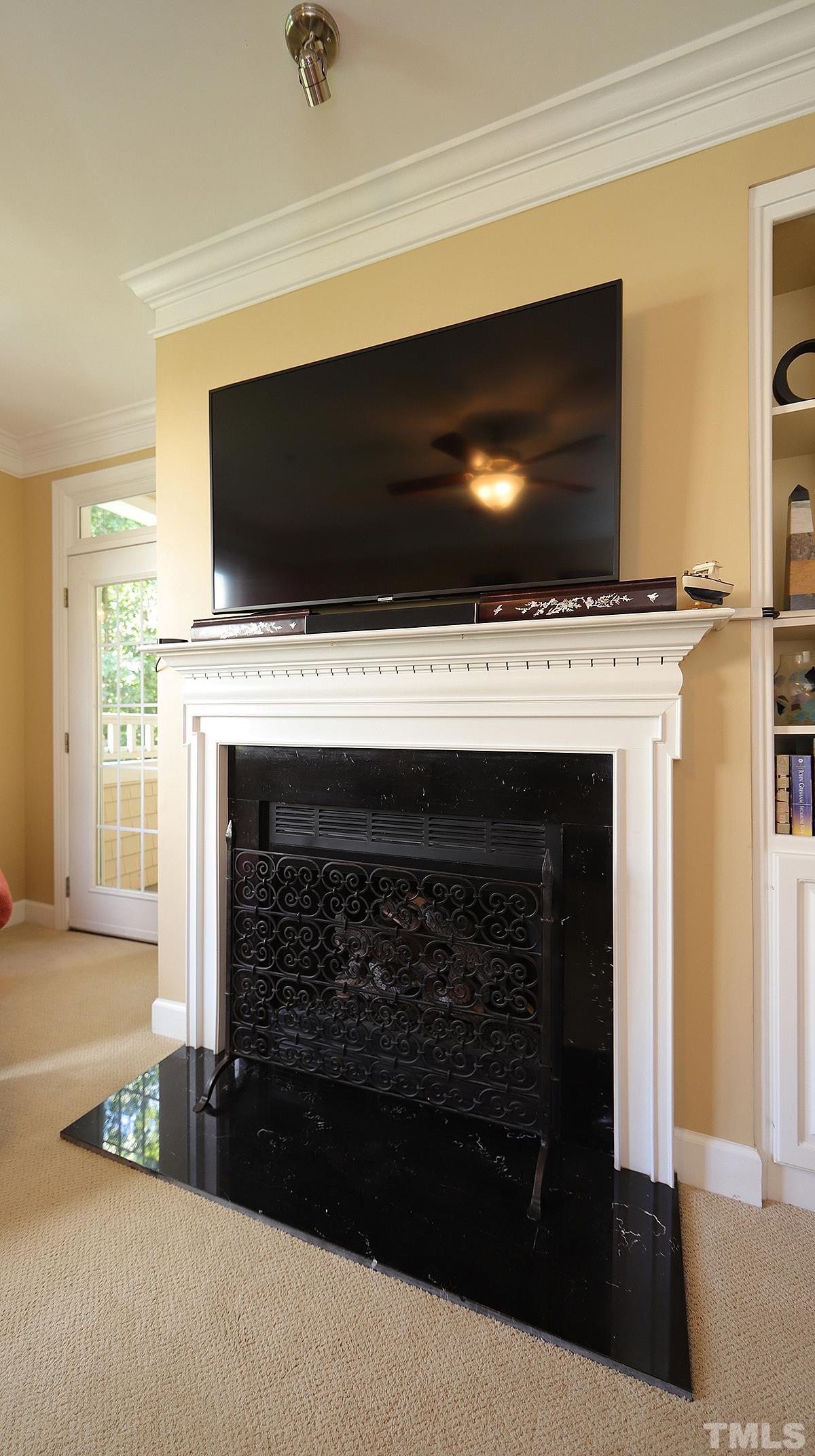 100 Northbrook Drive, Unit 203 Raleigh, NC 27609 - Photo 10 of 39 a living room with a fireplace and a flat screen tv