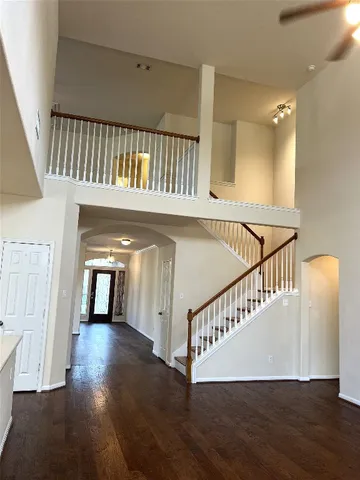 a view of staircase with lots of frames and a wooden floor