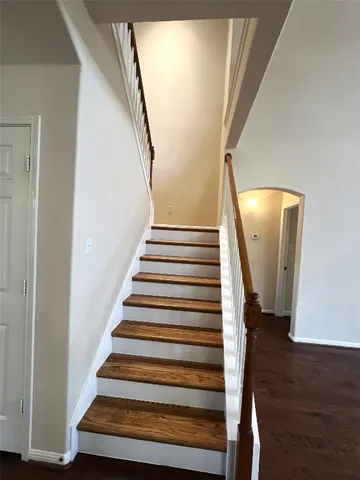 a view of staircase with lots of frames and a floor to ceiling window