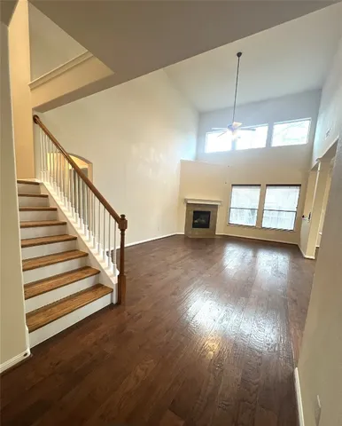 a view of a room with wooden floor and window