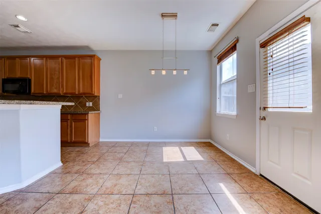 a kitchen with a stove a sink and a refrigerator