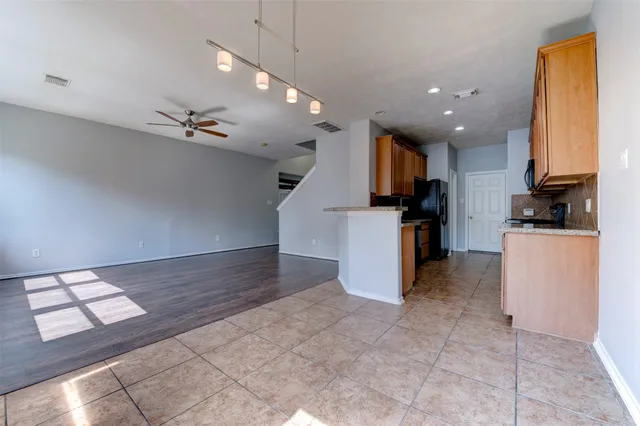 a view of kitchen with microwave and cabinets