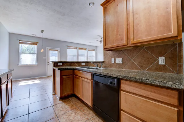 a kitchen with stainless steel appliances granite countertop a sink stove and cabinets