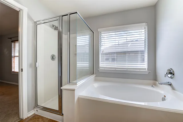 a bathroom with a bathtub and a shower