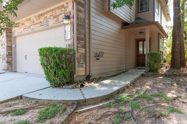 a view of a backyard with plants and brick walls