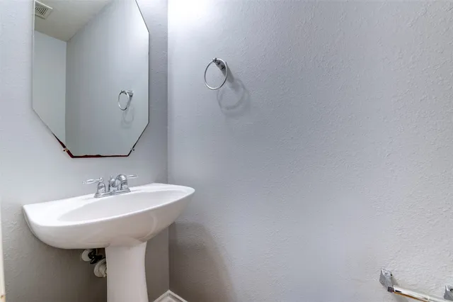 a bathroom with a sink and mirror