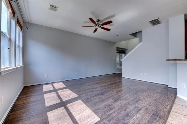 wooden floor in an empty room with a window