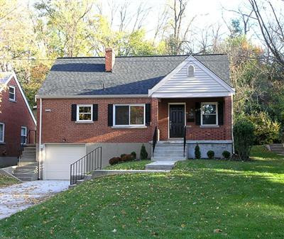 Cute Cape Cod home with newly remodeled front yard featuring front porch, new driveway, and all new landscaping.