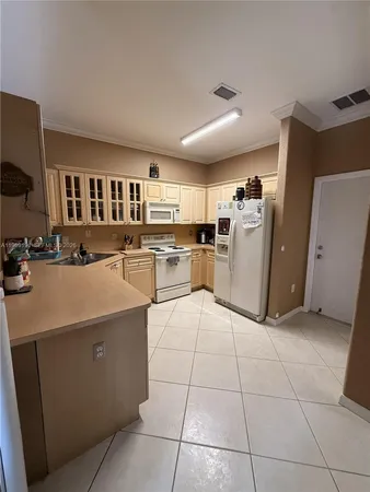 a kitchen with refrigerator and cabinets