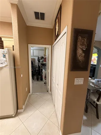 a view of a hallway with windows and closet