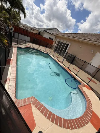 a view of a swimming pool with a yard
