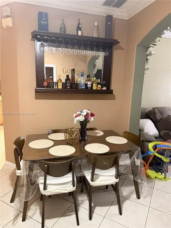 a view of a dining room with furniture and chandelier