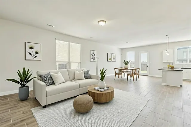 a living room with furniture and wooden floor