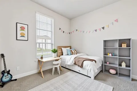 a bedroom with a bed and a window