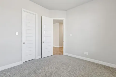 an empty room with closet area