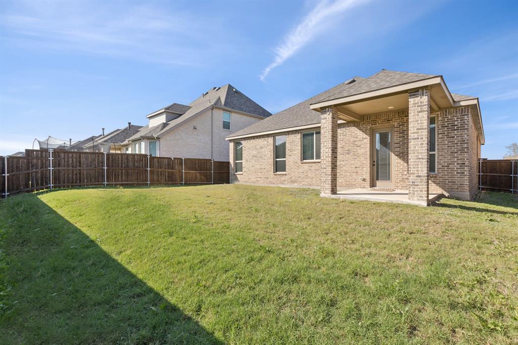 1222 El Sol Boulevard Sherman, TX 75090 - Photo 28 of 39 a view of a house with a backyard and a garden