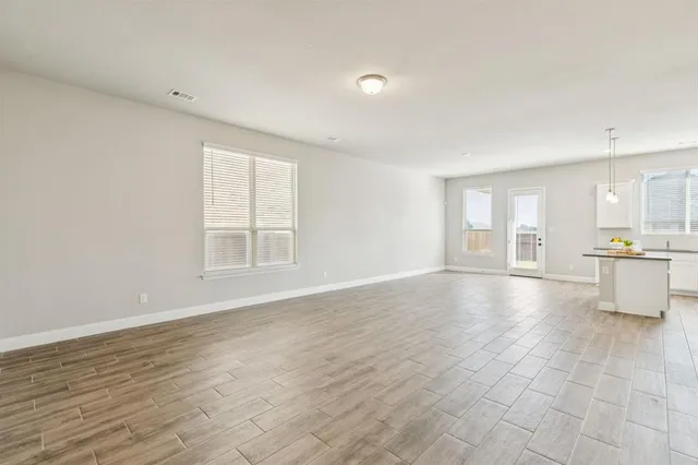 a view of an empty room with glass door and entryway