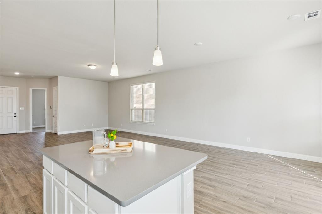 1222 El Sol Boulevard Sherman, TX 75090 - Photo 9 of 39 a view of a kitchen area with furniture and wooden floor