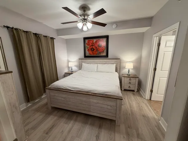 a bedroom with a bed and a flat tv screen on a dresser