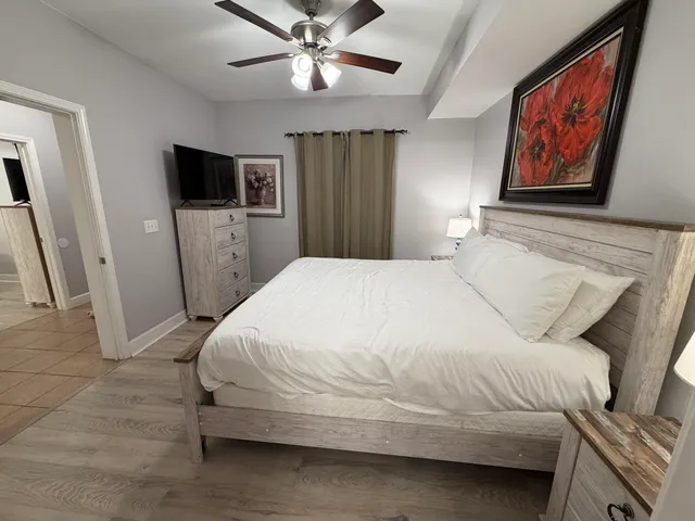 a bedroom with a bed and a flat screen tv