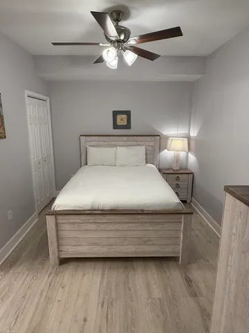 a view of a hallway with a glass door and furniture