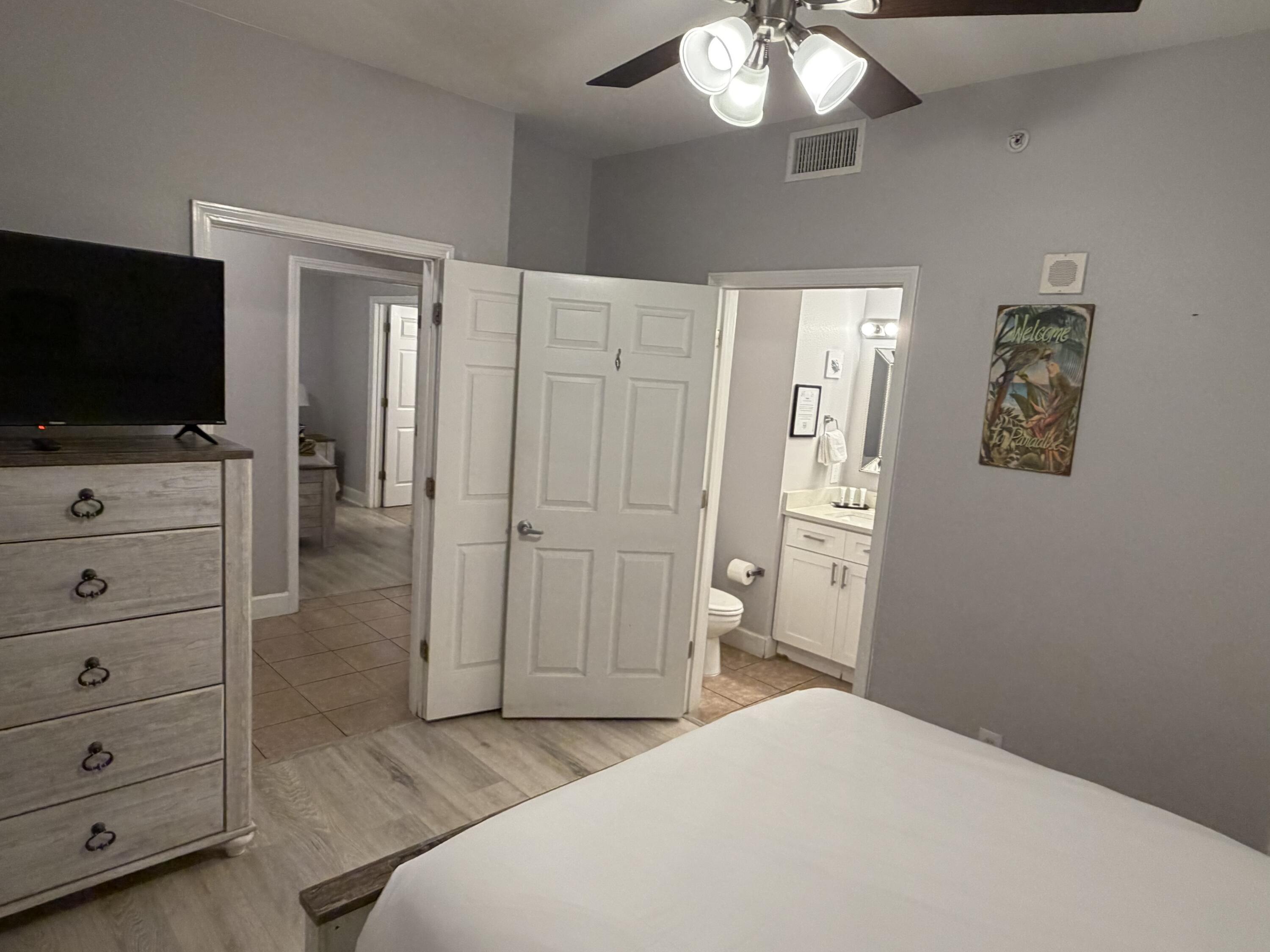 16819 Front Beach Road, Unit 2214 Panama City Beach, FL 32413 - Photo 19 of 49 a bedroom with a bed and a flat screen tv