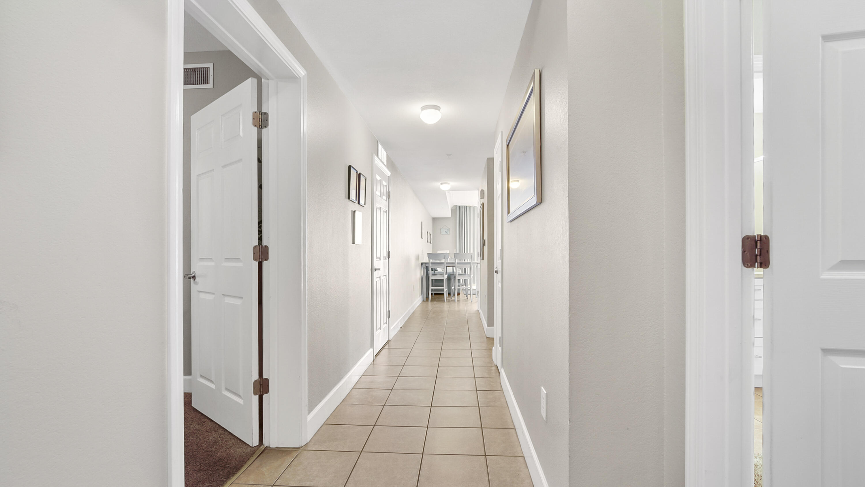 16819 Front Beach Road, Unit 2214 Panama City Beach, FL 32413 - Photo 26 of 49 a view of a hallway with a glass door and furniture