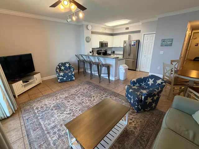 a living room with furniture and a floor to ceiling window