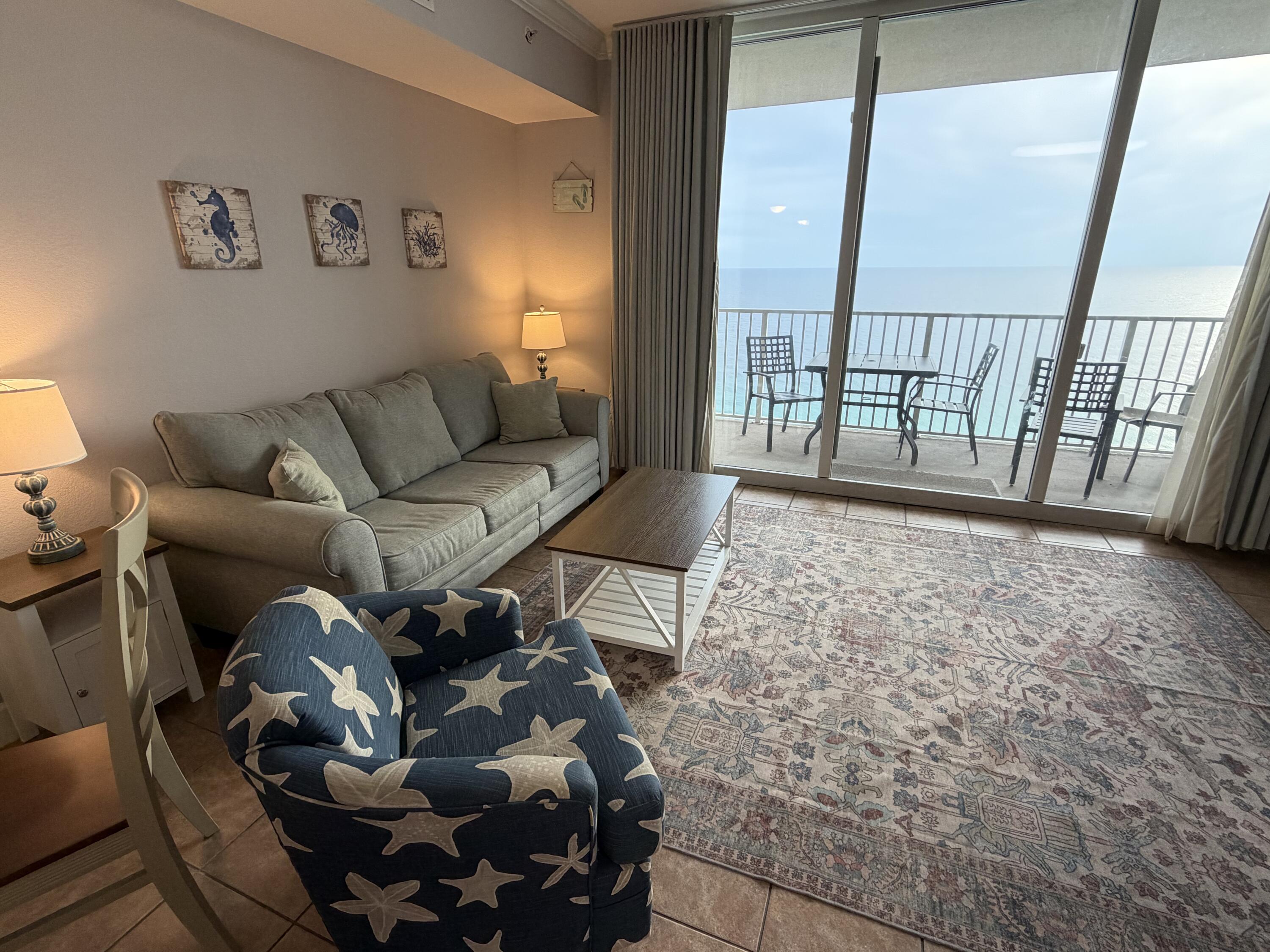 16819 Front Beach Road, Unit 2214 Panama City Beach, FL 32413 - Photo 4 of 49 a living room with furniture and a floor to ceiling window