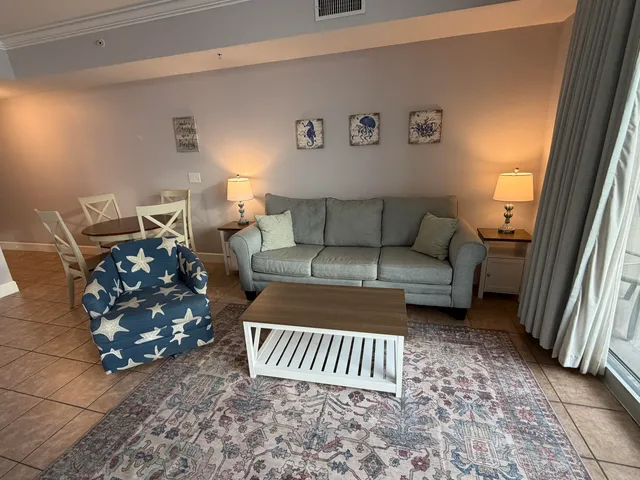a living room with a couch and a lamp with wooden floor