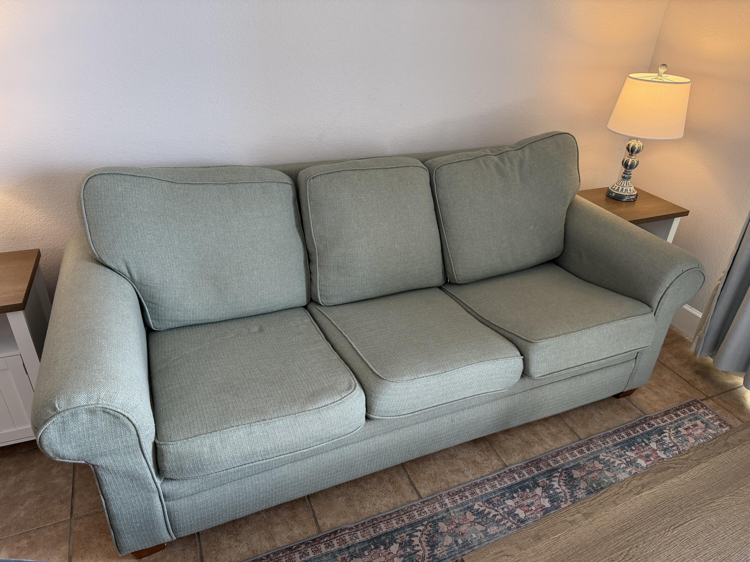 16819 Front Beach Road, Unit 2214 Panama City Beach, FL 32413 - Photo 7 of 49 a living room with a couch and a lamp with wooden floor