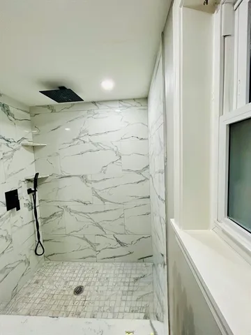 a bathroom with a shower and a sink