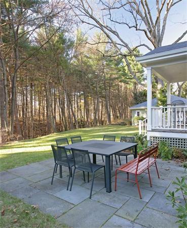 151 Plymouth Road Newton, MA 02461 - Photo 11 of 12 a table and chairs in a garden
