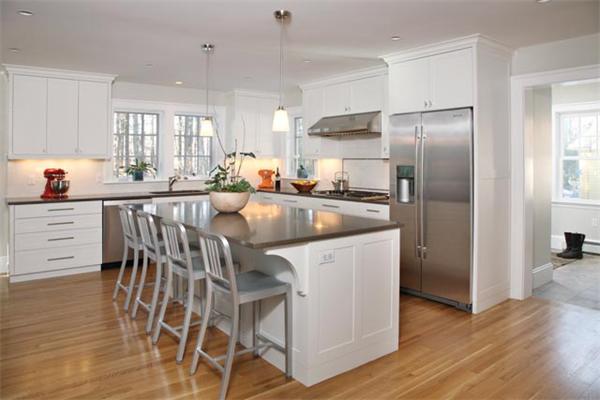151 Plymouth Road Newton, MA 02461 - Photo 4 of 12 a kitchen with stainless steel appliances granite countertop a table chairs refrigerator and sink
