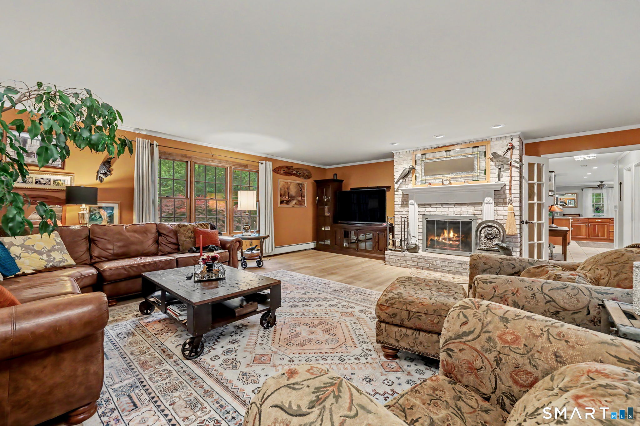 571 Wheeler Road Monroe, CT 06468 - Photo 15 of 40 a living room with furniture large window and a fireplace