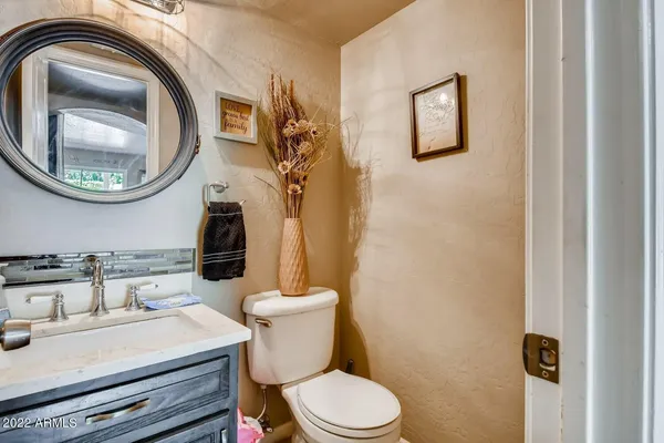 a bathroom with a sink a toilet and a mirror