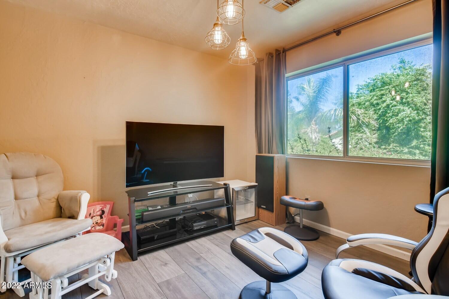 689 South Dodge Street Gilbert, AZ 85233 - Photo 19 of 28 a living room with furniture and a flat screen tv