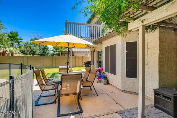 a view of an outdoor sitting area with furniture and umbrella