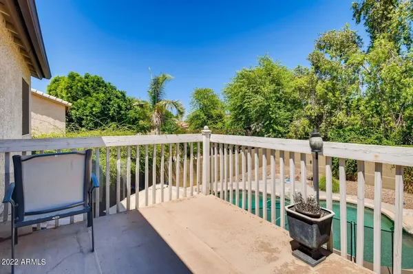 a view of a balcony with chair and potted plants
