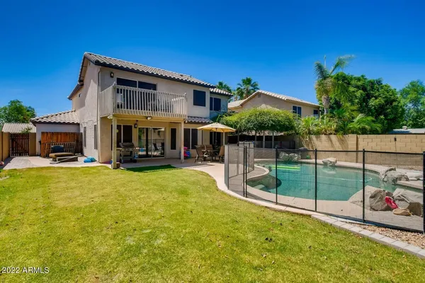 a view of an house with backyard and patio