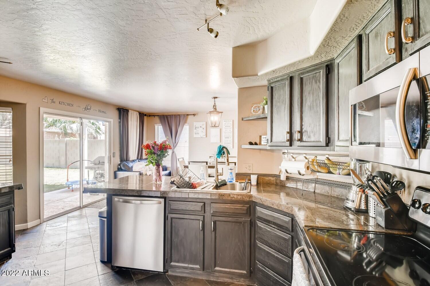689 South Dodge Street Gilbert, AZ 85233 - Photo 7 of 28 a kitchen with sink cabinets and outdoor view