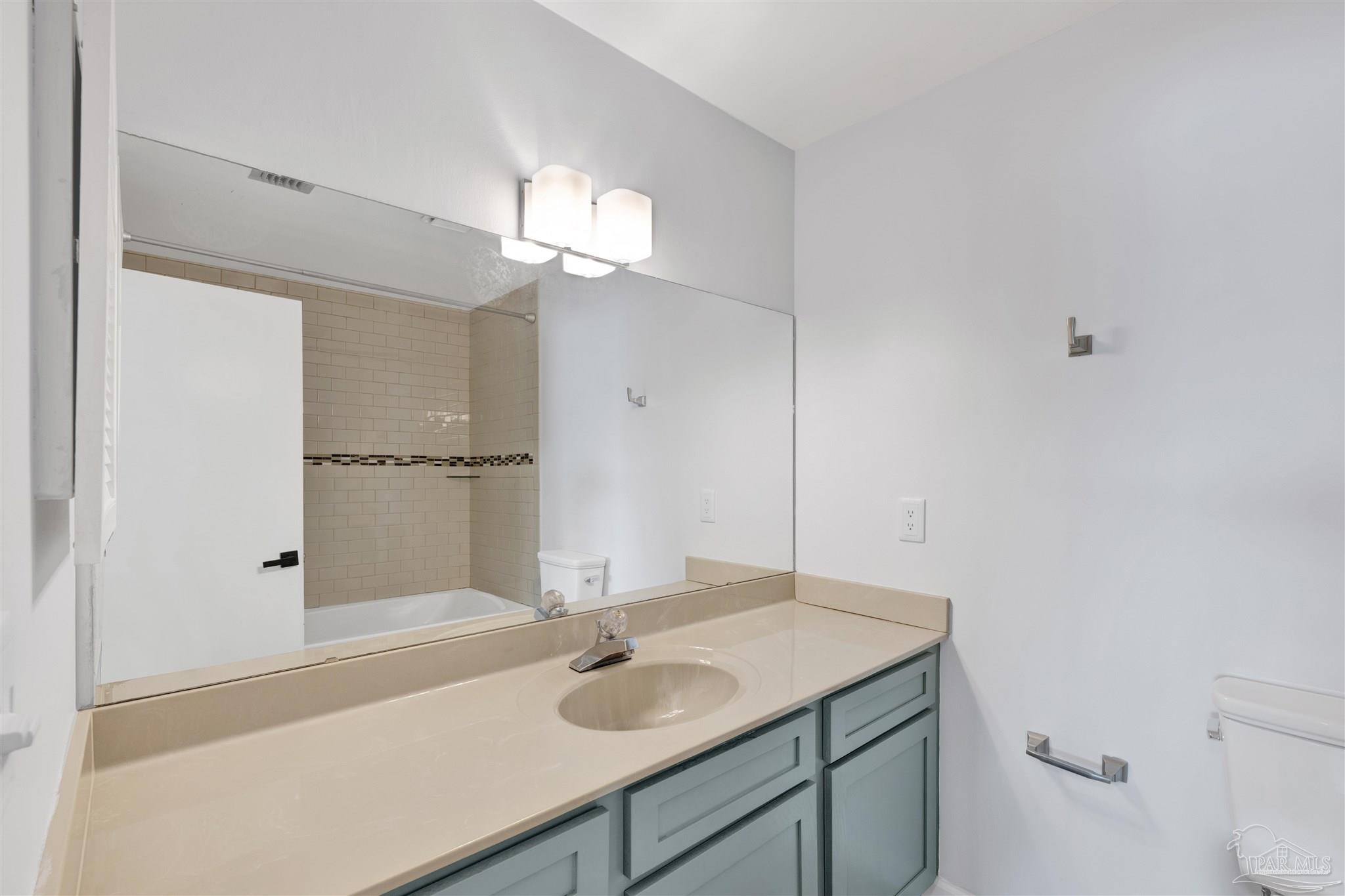 14100 River Road, Unit 334 Perdido Key, FL 32507 - Photo 21 of 35 a bathroom with a sink and a mirror