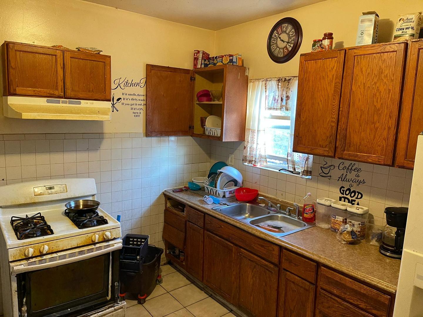 6950 South Carpenter Street Chicago, IL 60621 - Photo 3 of 3 a kitchen with a stove and cabinets