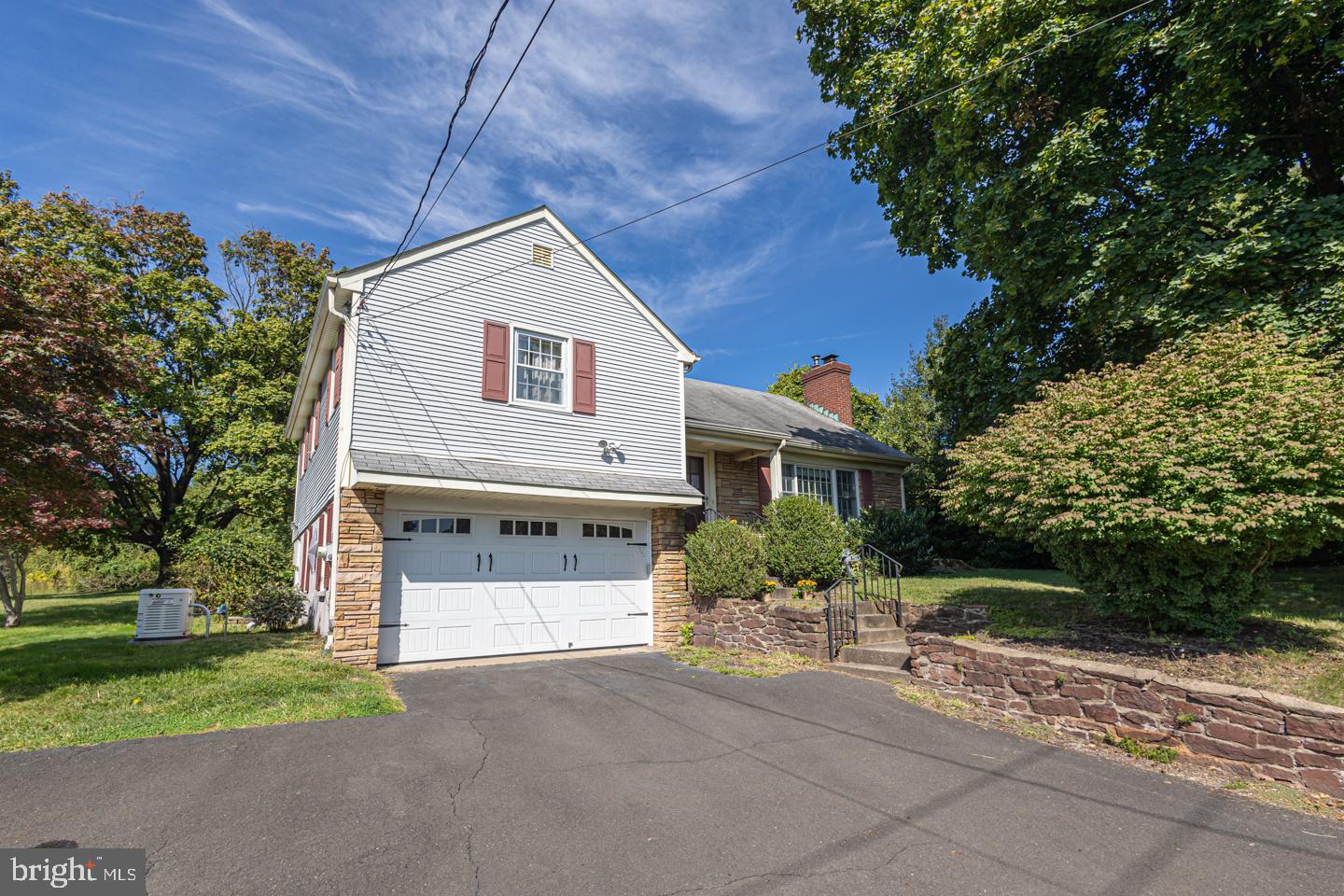 54 Eagle Road Newtown, PA 18940 - Photo 2 of 31 a front view of a house with a yard and a garage