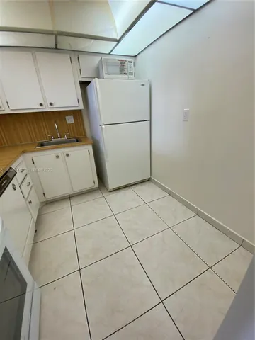 a kitchen with cabinets and appliances