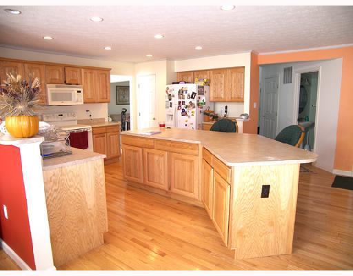 Kitchen. Isalnd kitchen offers hardwood floors, recessed lighting, pantry and walks out to deck.
