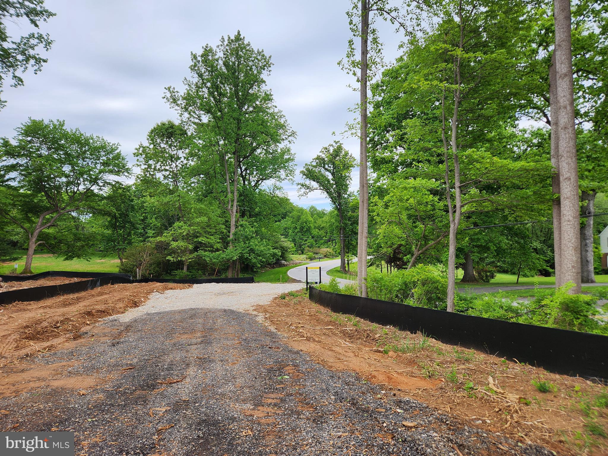 13823 Brighton Dam Road Clarksville, MD 21029 - Photo 33 of 35 a view of a road with a yard and fountain in the back yard