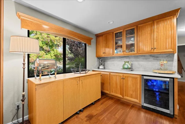 a kitchen with stainless steel appliances granite countertop a refrigerator a stove and a sink